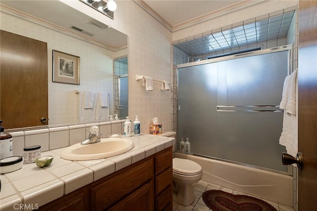 full bathroom with combined bath / shower with glass door, tile patterned floors, toilet, vanity, and ornamental molding