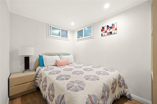 bedroom with wood-type flooring and crown molding