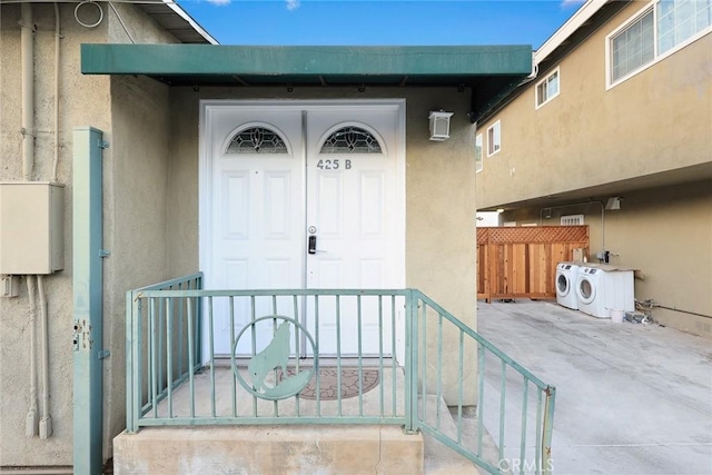 doorway to property with washer and dryer