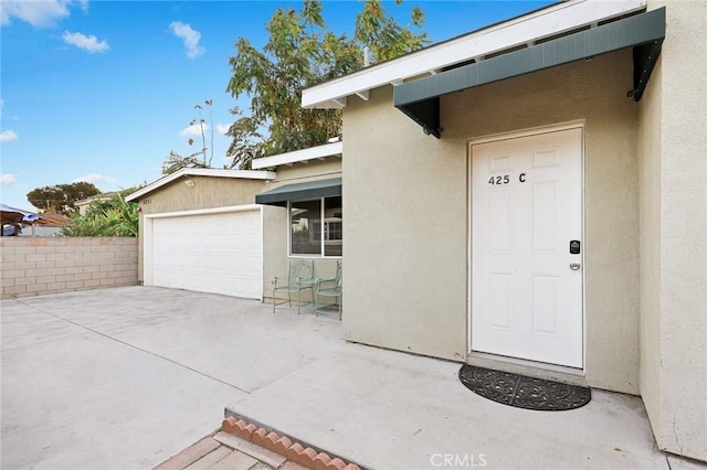 view of exterior entry featuring a garage