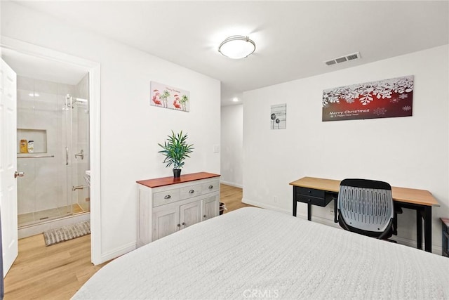 bedroom featuring ensuite bathroom and light hardwood / wood-style flooring