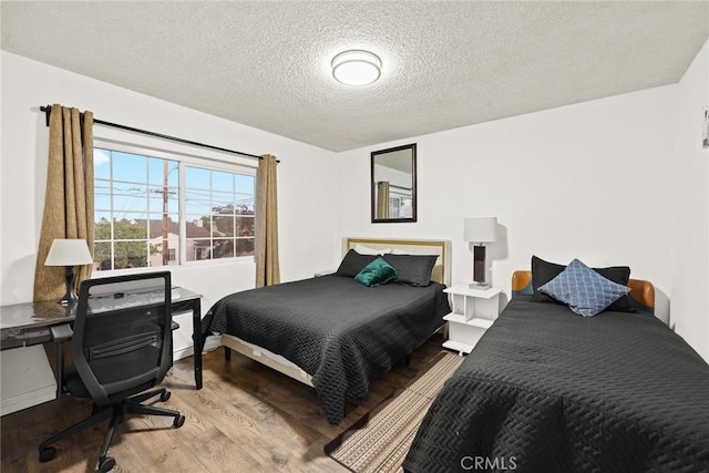 bedroom featuring light hardwood / wood-style floors and a textured ceiling