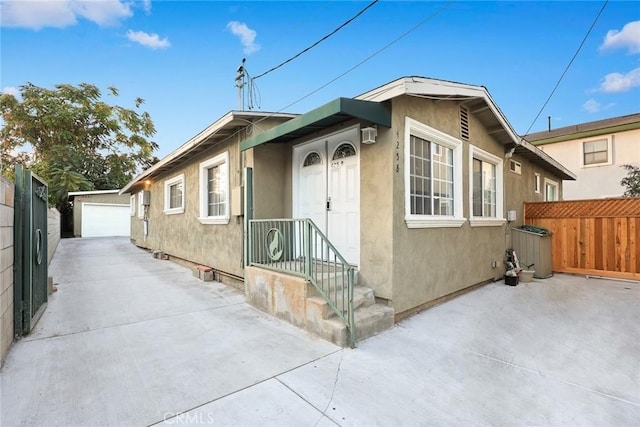 view of front of house featuring a garage and an outdoor structure