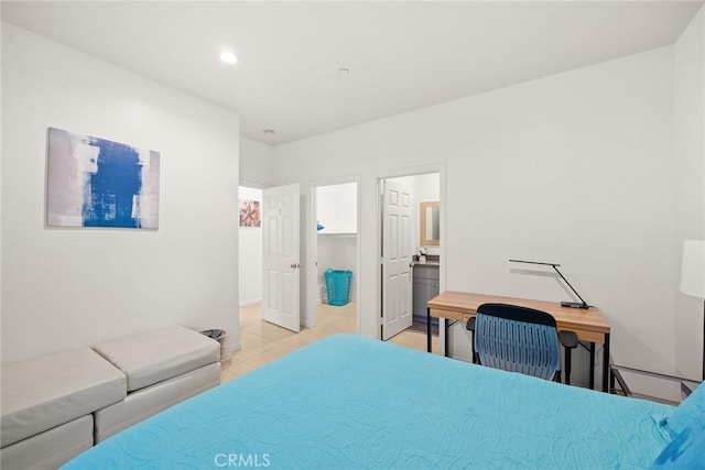 bedroom featuring ensuite bath and light tile patterned floors