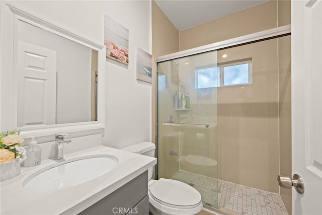 bathroom featuring vanity, toilet, and a shower with shower door