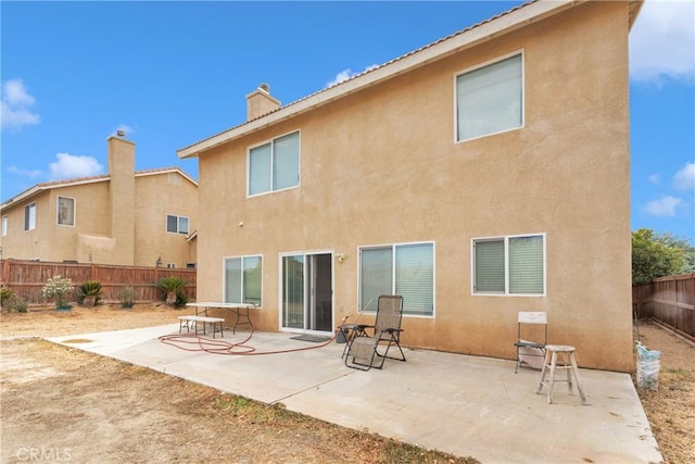 rear view of property featuring a patio area