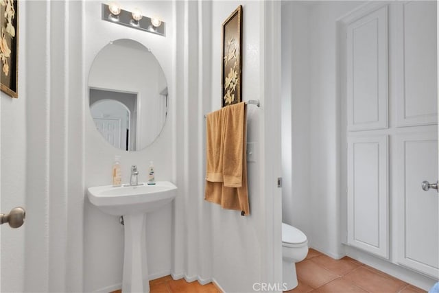 bathroom with tile patterned flooring, toilet, and sink