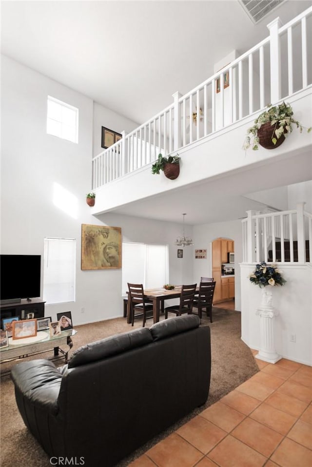 tiled living room featuring a high ceiling