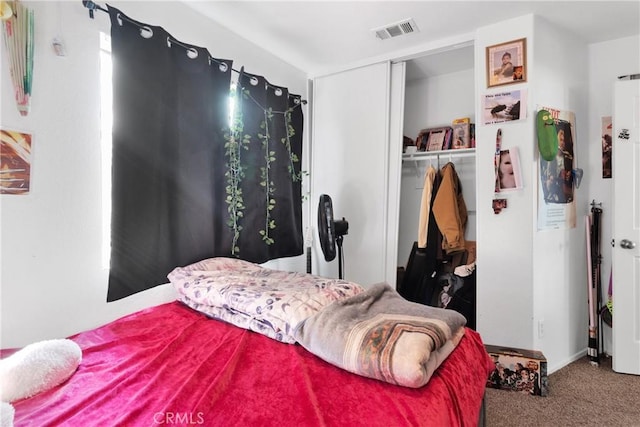 carpeted bedroom featuring a closet