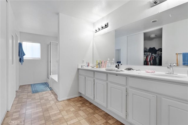 bathroom featuring plus walk in shower and vanity