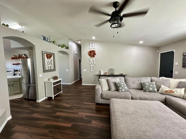 living room with dark hardwood / wood-style floors and ceiling fan