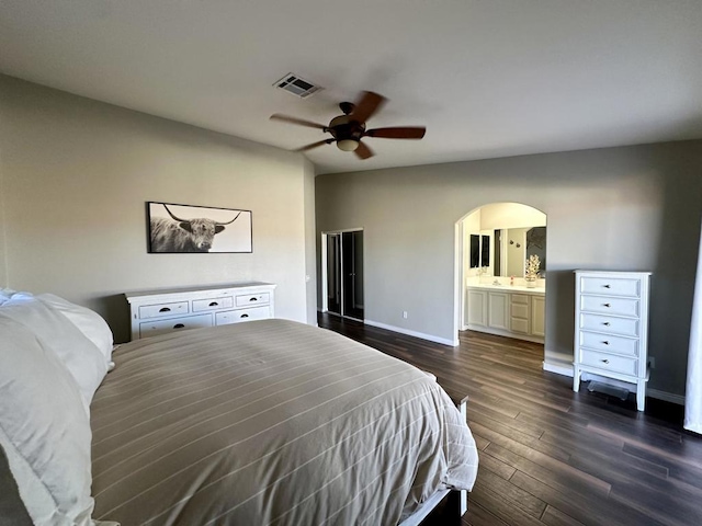 bedroom with ensuite bath, ceiling fan, and dark wood-type flooring