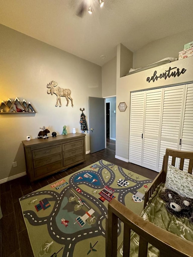 bedroom featuring dark wood-type flooring and lofted ceiling