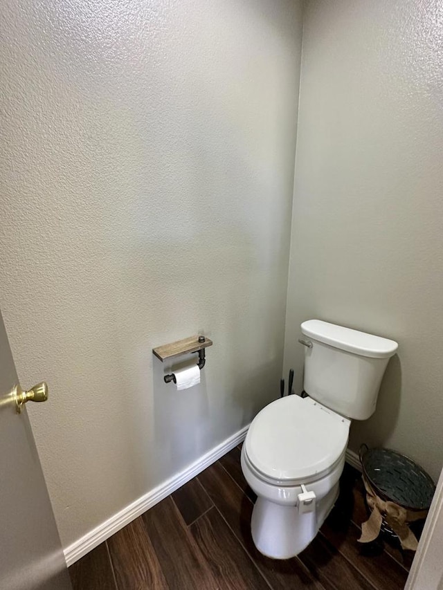 bathroom with wood-type flooring and toilet