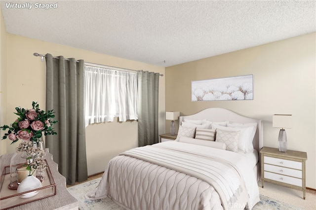 carpeted bedroom with a textured ceiling