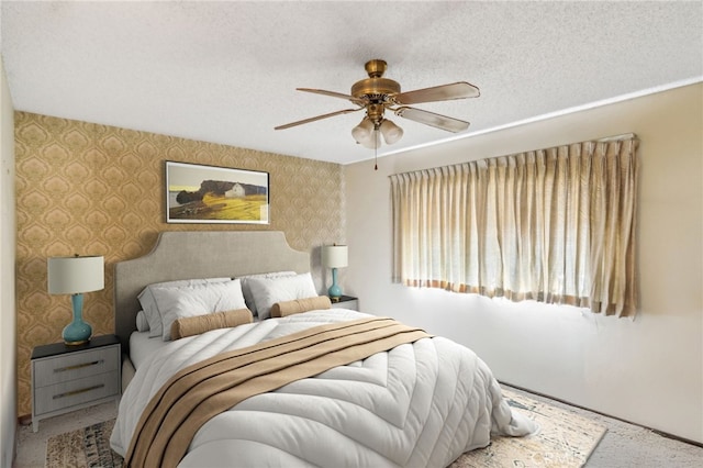 bedroom with carpet flooring, a textured ceiling, and ceiling fan