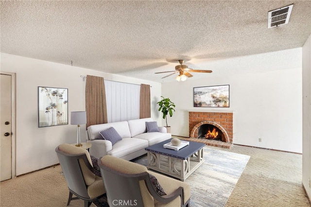 living room featuring a textured ceiling, ceiling fan, light carpet, and a brick fireplace