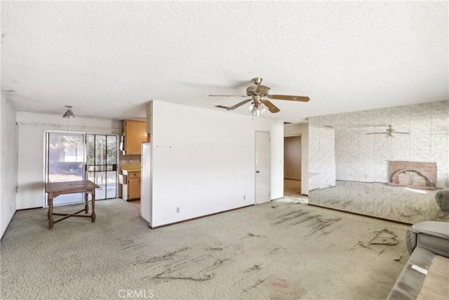 carpeted living room featuring a textured ceiling and ceiling fan