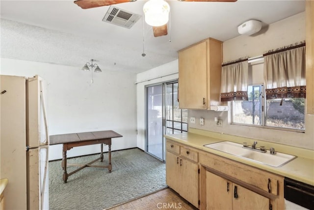 kitchen featuring black dishwasher, white refrigerator, sink, and light brown cabinetry