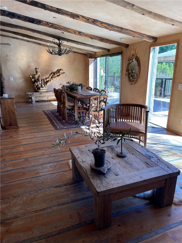 interior space featuring beamed ceiling, a wealth of natural light, and dark wood-type flooring