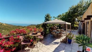 view of patio featuring a gazebo and outdoor dining space