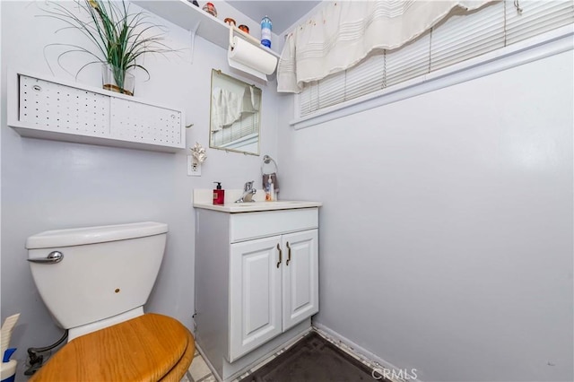 bathroom featuring vanity and toilet