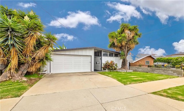 view of front of house featuring a garage and a front lawn