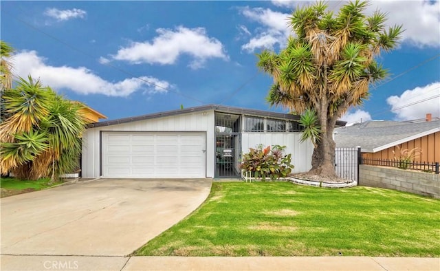 single story home featuring a garage and a front lawn