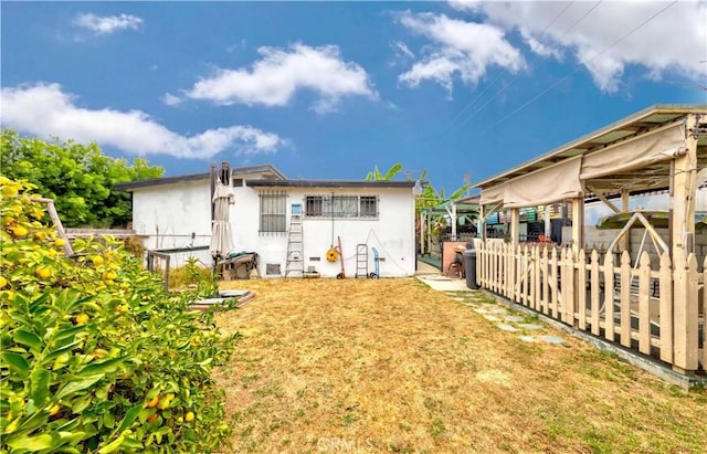 rear view of property featuring a yard