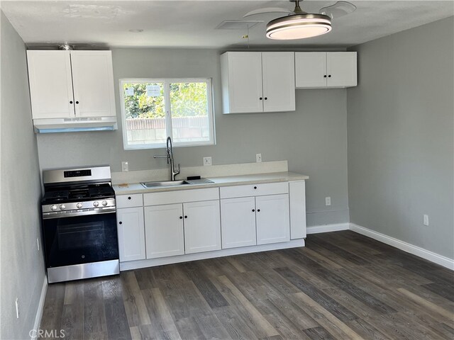 kitchen with stainless steel range, dark hardwood / wood-style flooring, white cabinets, and sink