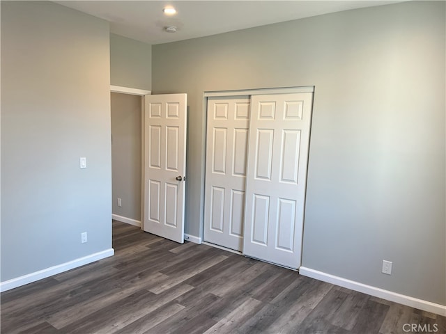 unfurnished bedroom featuring dark hardwood / wood-style floors and a closet