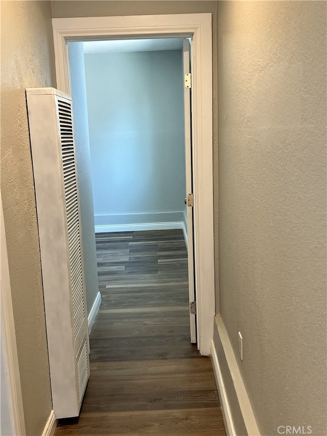 corridor with dark wood-type flooring