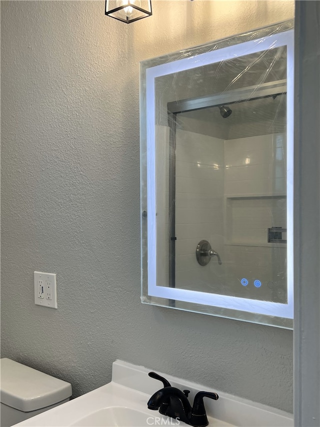 bathroom with walk in shower and toilet