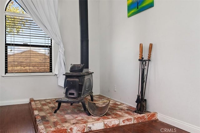 interior details with a wood stove and hardwood / wood-style floors