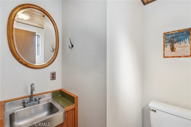 bathroom featuring sink and toilet