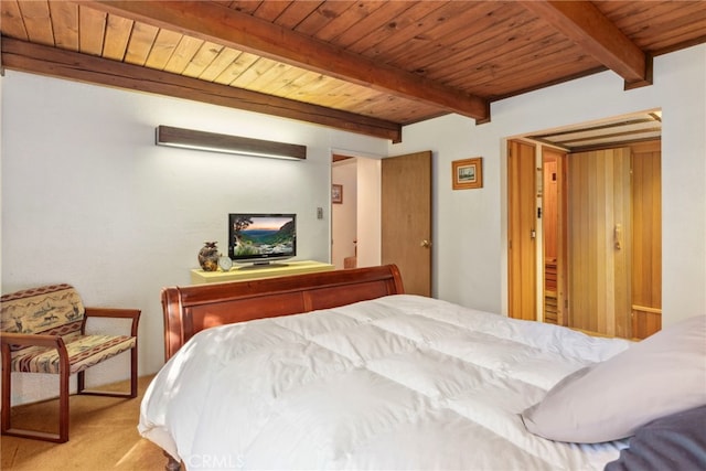 bedroom featuring beam ceiling, wood ceiling, and light carpet