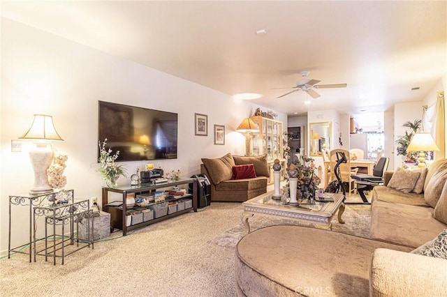 living room featuring carpet floors and ceiling fan