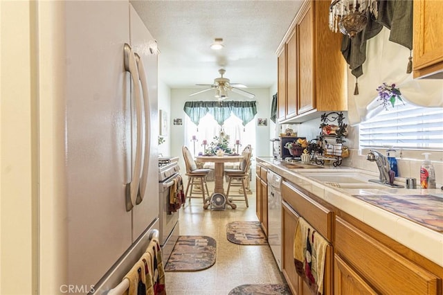 19046 Stoddard Way, Apple Valley, CA 92308 - kitchen with white appliances, a ceiling fan, plenty of natural light, and tile countertops