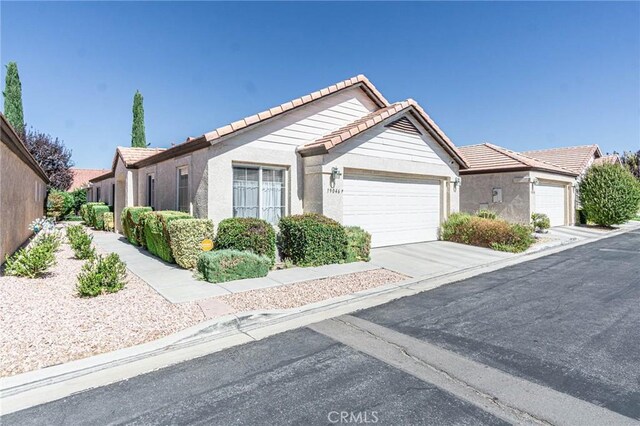 19046 Stoddard Way, Apple Valley, CA 92308 - ranch-style home with a garage, a tile roof, stucco siding, and concrete driveway