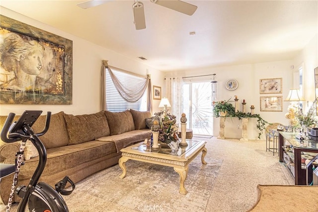 carpeted living room with ceiling fan