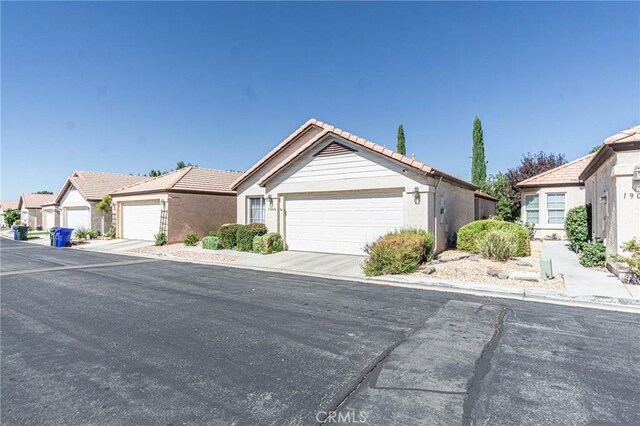 19046 Stoddard Way, Apple Valley, CA 92308 - single story home featuring a tile roof, an attached garage, stucco siding, and a residential view