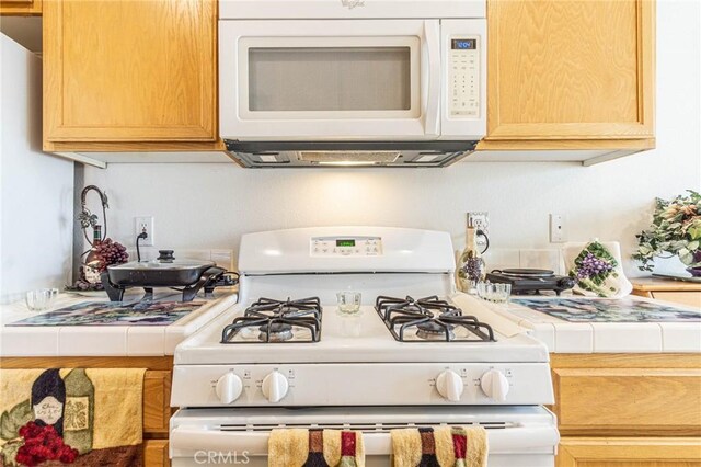 19046 Stoddard Way, Apple Valley, CA 92308 - kitchen featuring white appliances and tile counters
