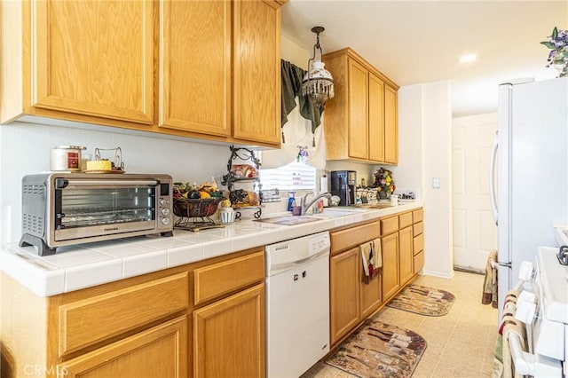 kitchen featuring sink, white appliances, tile countertops, and light tile patterned flooring