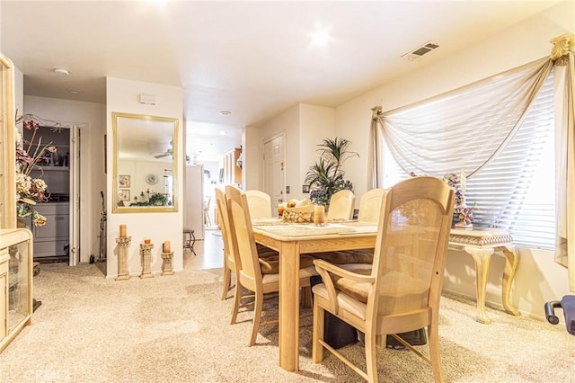 dining room with a healthy amount of sunlight and light carpet