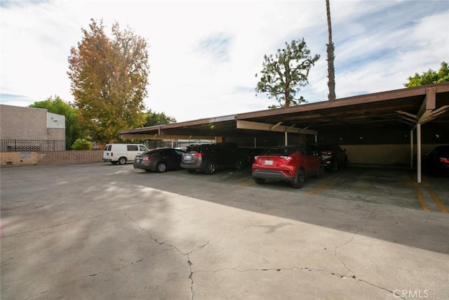 view of parking / parking lot featuring a carport