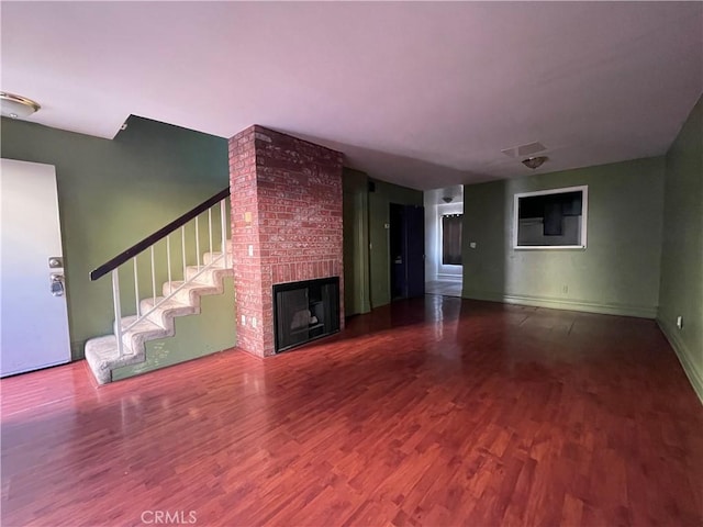 unfurnished living room featuring a fireplace and hardwood / wood-style floors