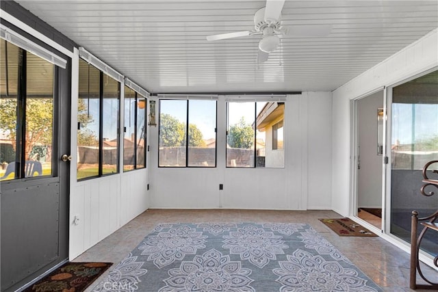 sunroom / solarium featuring ceiling fan