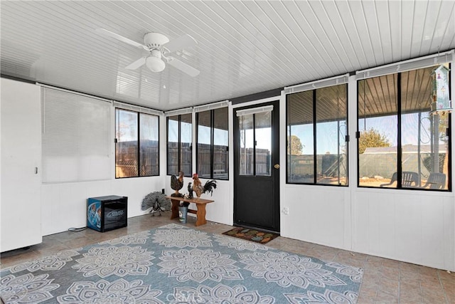 unfurnished sunroom featuring plenty of natural light and ceiling fan