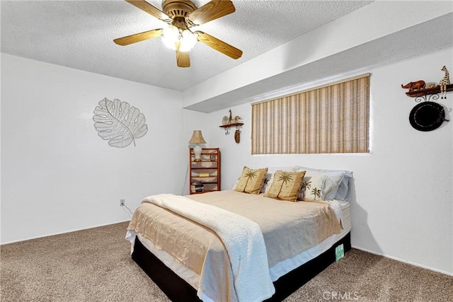 carpeted bedroom with ceiling fan and a textured ceiling