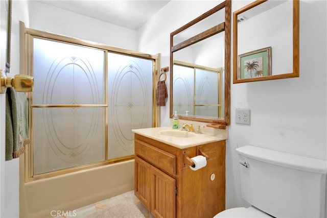 full bathroom featuring combined bath / shower with glass door, vanity, toilet, and tile patterned flooring